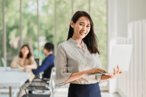 gen z holding laptop